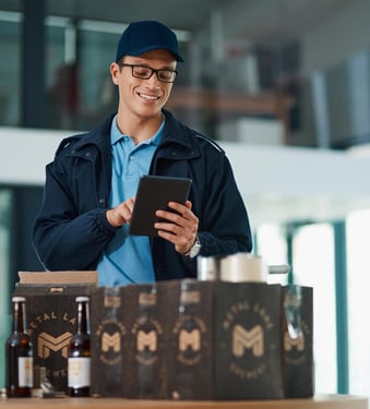 brewery-worker-with-samples-looking-at-tablet